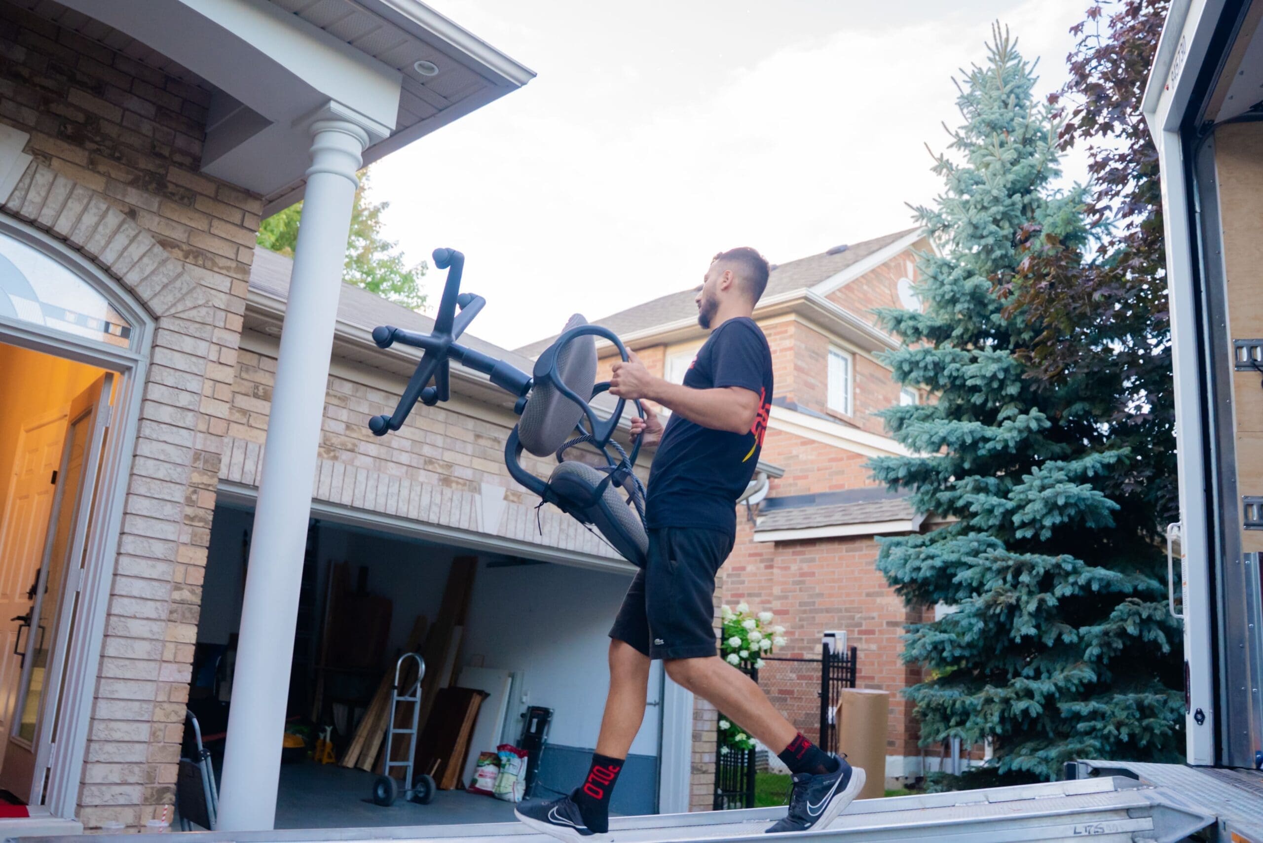 Flash Moving crew carrying wrapped furniture during a Brampton move