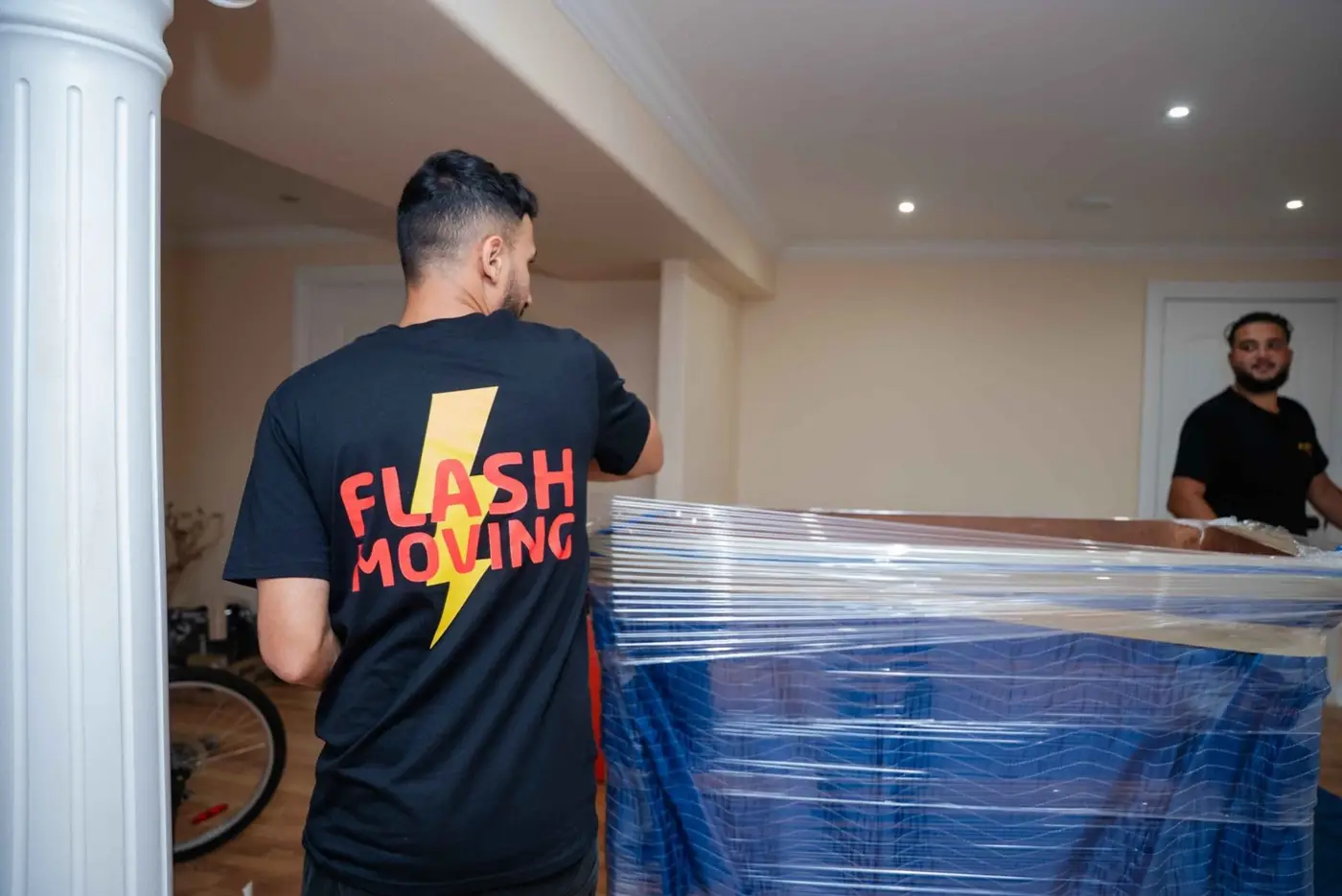 Flash Moving crew member moving wrapped furniture