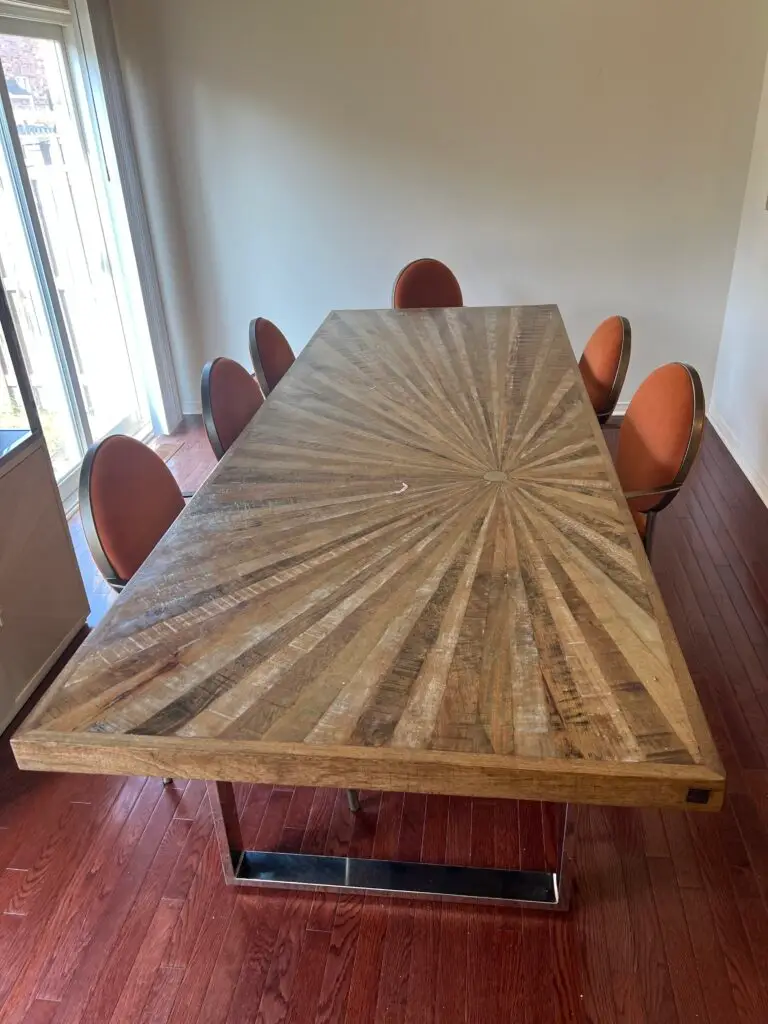Large custom wooden commercial table with a delicate sunburst wood grain pattern, representing the high-value, heavy furniture Flash Moving safely commercial move in Mississauga for clients in the Greater Toronto Area.