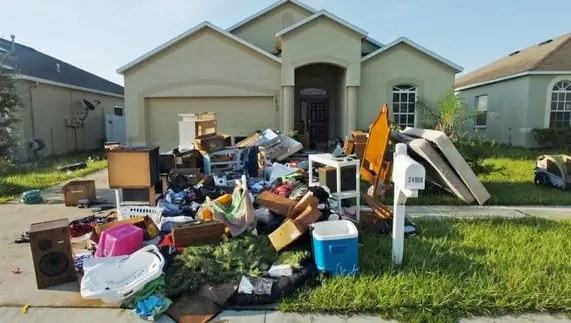 Old appliances and furniture being loaded for junk removal in Mississauga