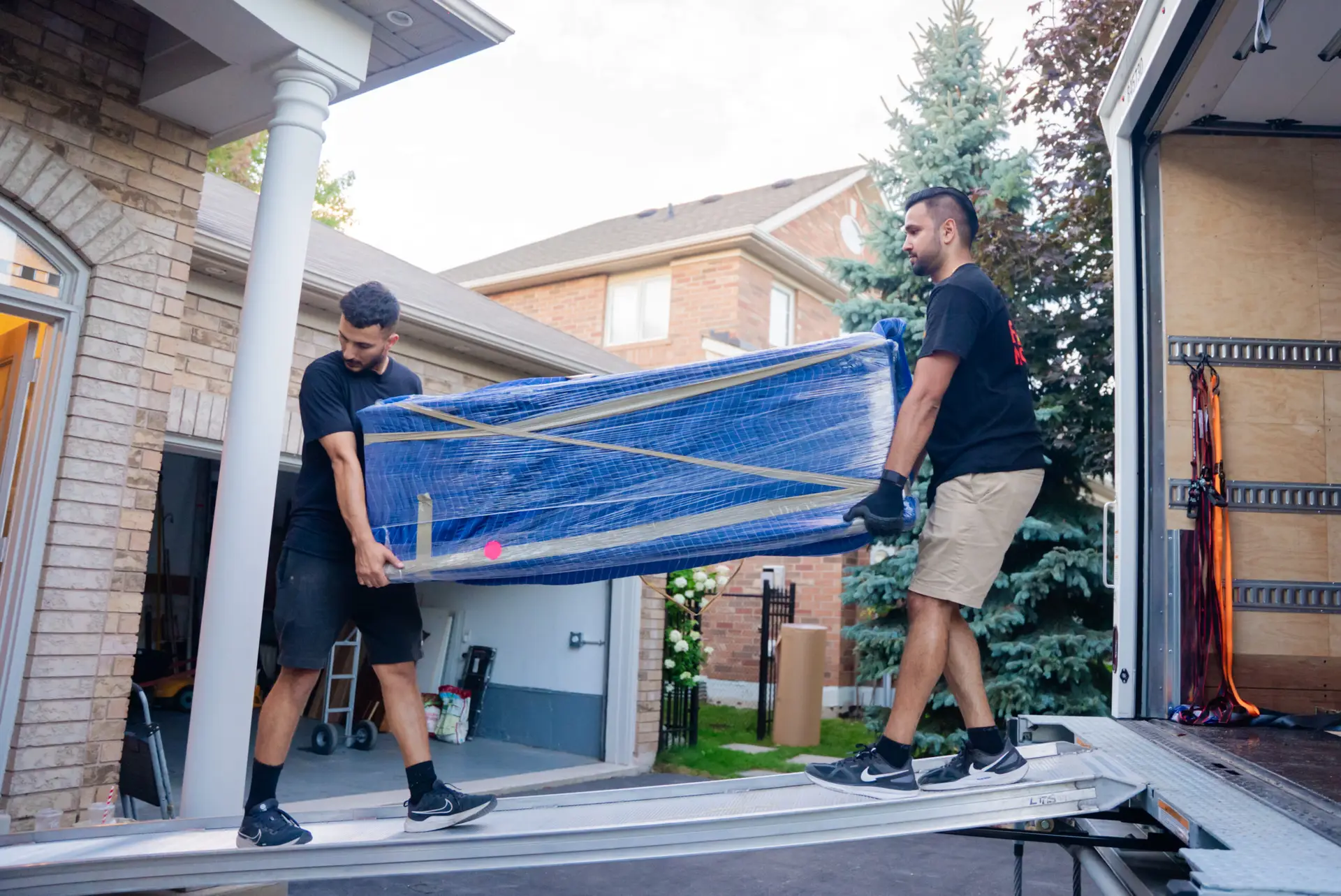 Flash Moving crew loading wrapped furniture into truck during a Mississauga residential move