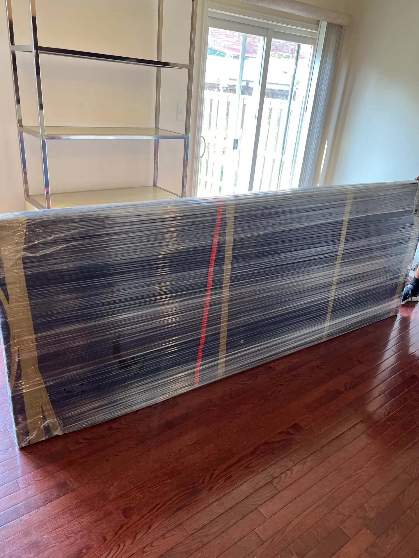 A large, fragile item professionally protected by Flash Moving using thick blue moving blankets, packing tape, and industrial stretch film to ensure zero damage during a commercial move in Mississauga.